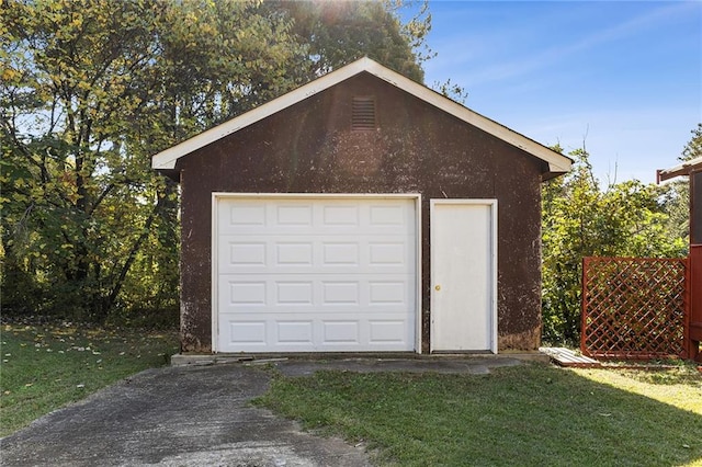 garage featuring a lawn