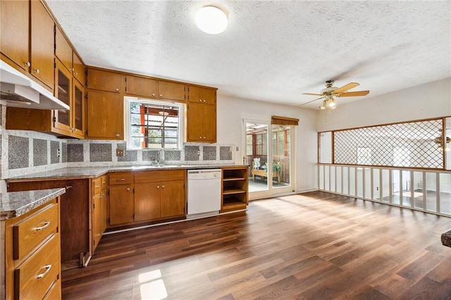 kitchen featuring dark hardwood / wood-style floors, backsplash, white dishwasher, a textured ceiling, and ceiling fan