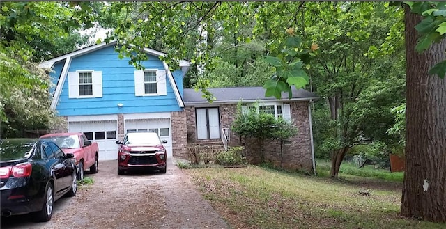 split level home featuring a garage, driveway, and brick siding