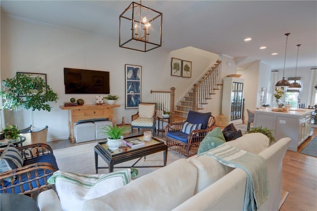 living area with stairway, recessed lighting, a chandelier, light wood-type flooring, and baseboards