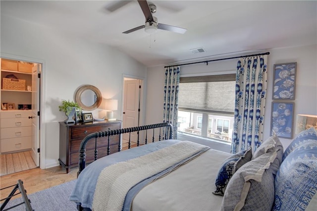 bedroom with wood finished floors, ceiling fan, lofted ceiling, and baseboards
