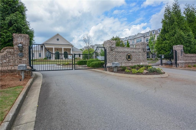 gate featuring fence and a residential view