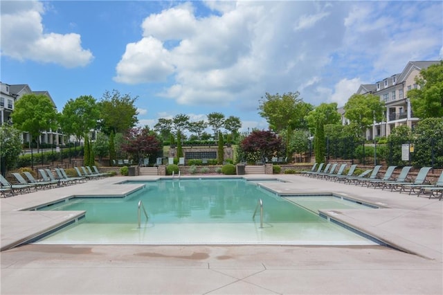 community pool featuring a patio and fence