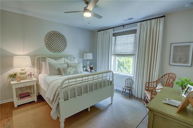 bedroom with wood finished floors, baseboards, and ceiling fan