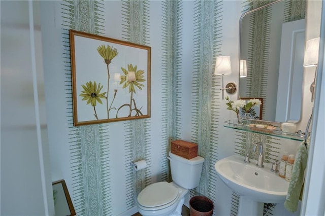 half bath featuring a sink and toilet
