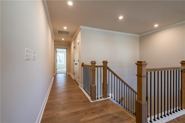 hall with hardwood / wood-style flooring and ornamental molding