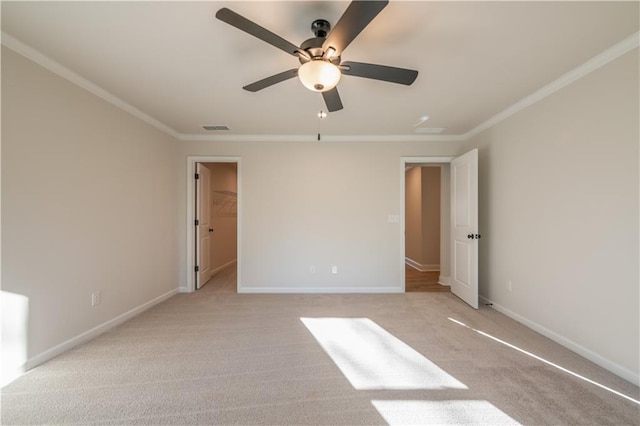 unfurnished bedroom featuring light colored carpet, a walk in closet, ornamental molding, and ceiling fan