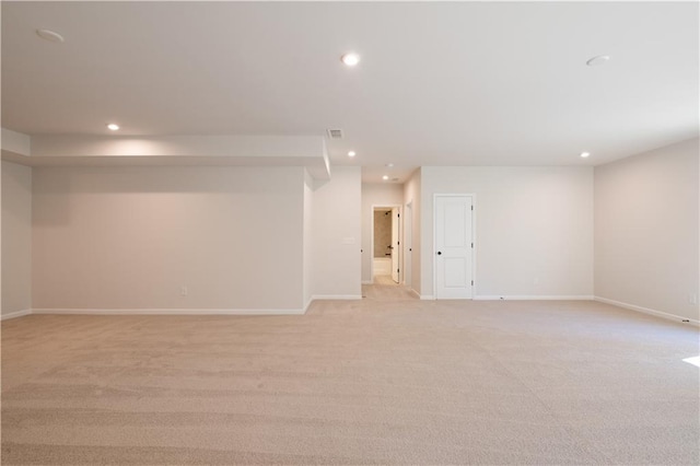 basement featuring light carpet