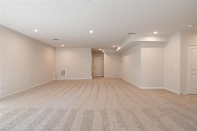 basement featuring light colored carpet