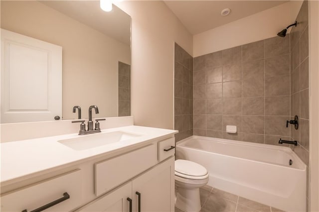 full bathroom with tile patterned floors, toilet, tiled shower / bath combo, and vanity