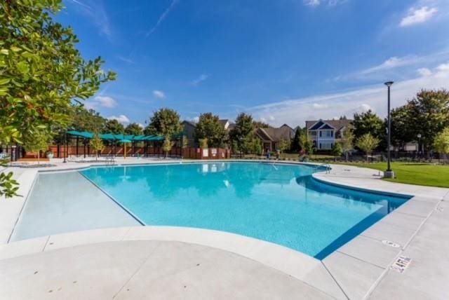 community pool featuring a patio area and fence