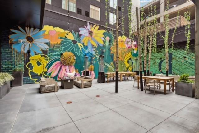 view of property's community featuring a fire pit and a patio