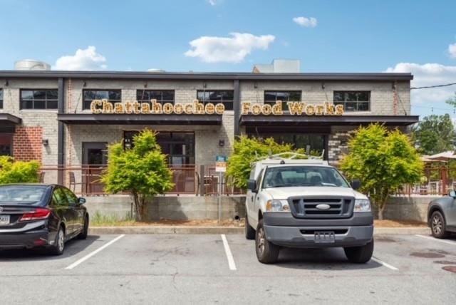 view of building exterior featuring uncovered parking