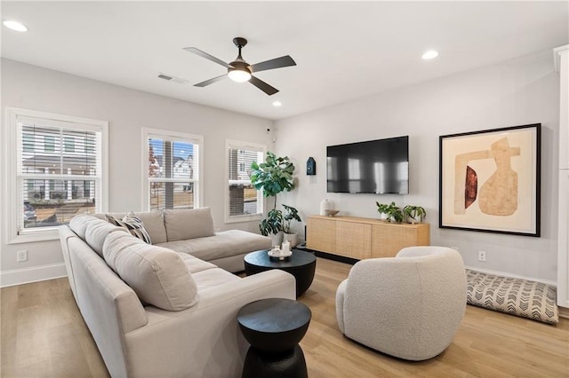 living area with visible vents, plenty of natural light, and light wood-style floors