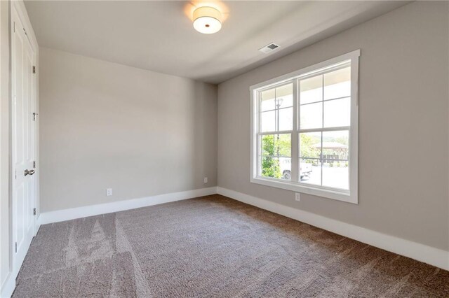 unfurnished bedroom featuring light carpet and a closet