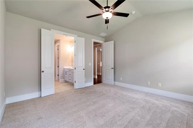 unfurnished bedroom featuring light colored carpet and a closet