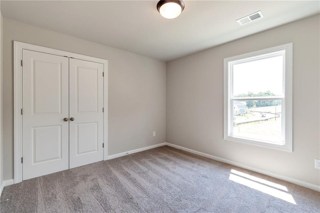 329 Willow Cv, Canton, GA 30114 - unfurnished bedroom featuring visible vents, baseboards, a closet, and carpet floors