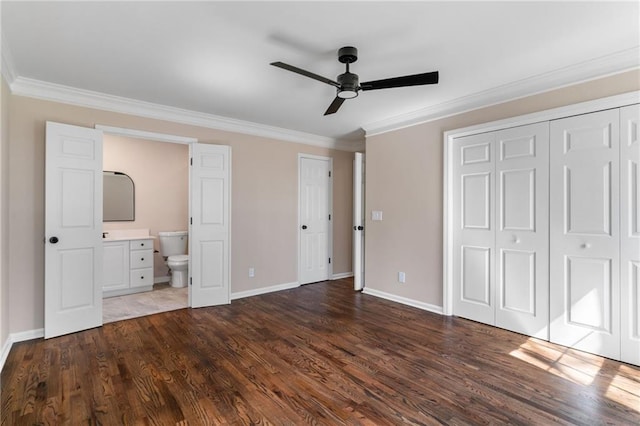 unfurnished bedroom with crown molding, dark wood-type flooring, and baseboards