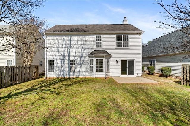 back of property with a patio area, fence, a lawn, and a chimney