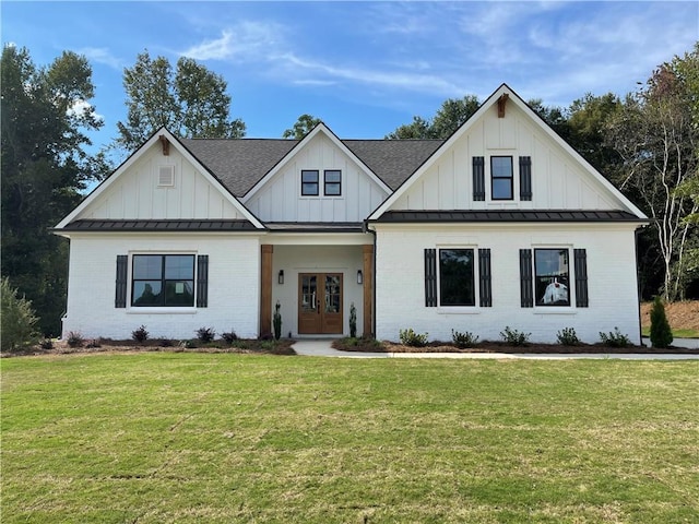 view of front of home with french doors and a front yard