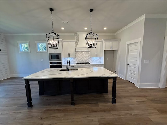 kitchen featuring appliances with stainless steel finishes, premium range hood, dark wood-type flooring, sink, and a large island