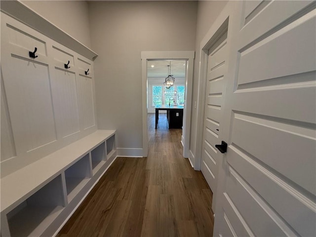 mudroom with a chandelier and dark hardwood / wood-style floors