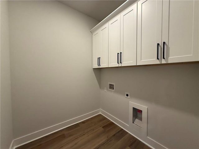 laundry room featuring electric dryer hookup, dark hardwood / wood-style flooring, hookup for a washing machine, and cabinets