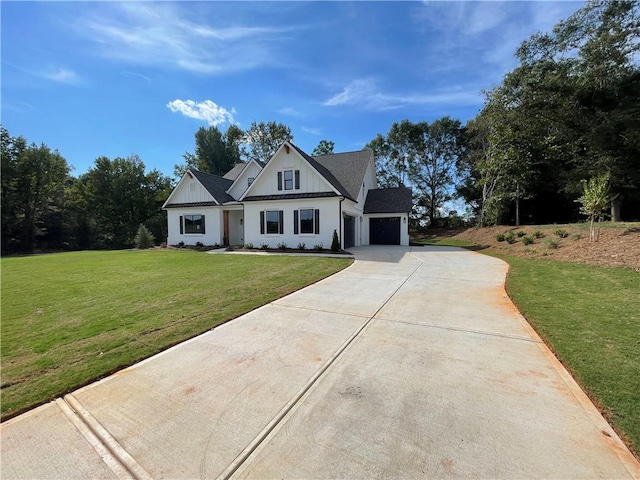 view of front facade with a garage and a front lawn