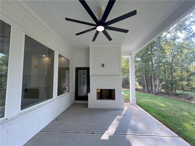 view of patio / terrace with an outdoor brick fireplace and ceiling fan