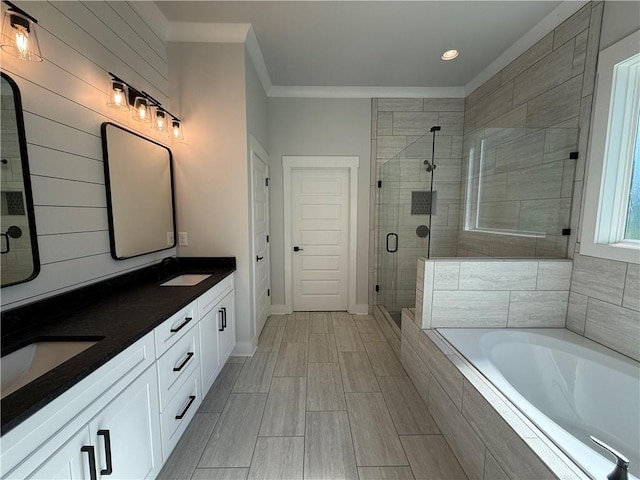 bathroom featuring vanity, ornamental molding, and independent shower and bath