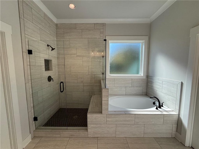 bathroom with tile patterned flooring, crown molding, and shower with separate bathtub