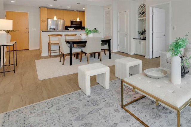 dining space with light hardwood / wood-style floors