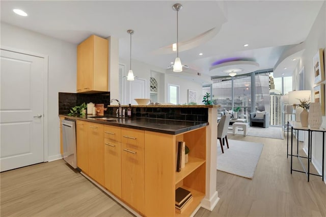 kitchen featuring light brown cabinets, sink, and kitchen peninsula