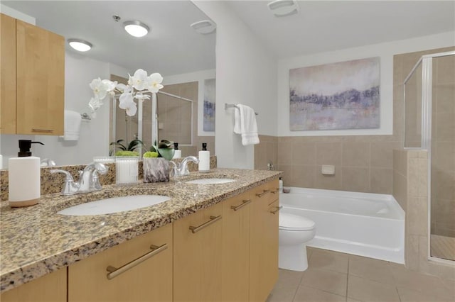 full bathroom featuring tile patterned flooring, shower with separate bathtub, vanity, and toilet