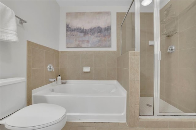 bathroom with tile patterned floors, toilet, and plus walk in shower