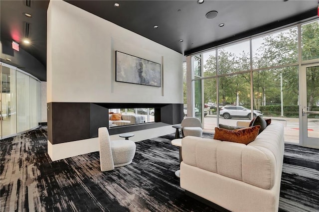 living room with expansive windows and hardwood / wood-style floors