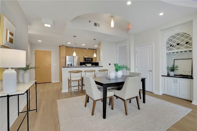 dining space with light wood-type flooring