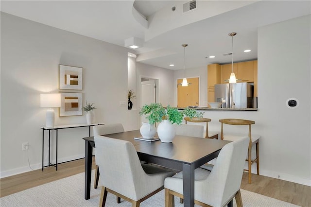 dining area featuring light wood-type flooring