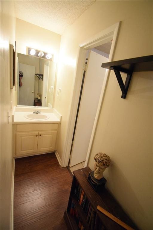 574 Trillum Ct SW, Marietta, GA 30008 - bathroom featuring wood finished floors, vanity, and a textured ceiling
