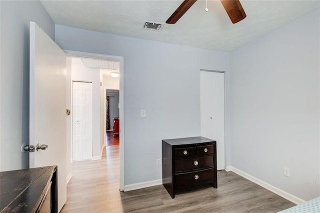 bedroom featuring light hardwood / wood-style flooring and ceiling fan