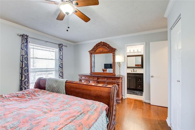 bedroom with sink, crown molding, ensuite bath, and light hardwood / wood-style floors