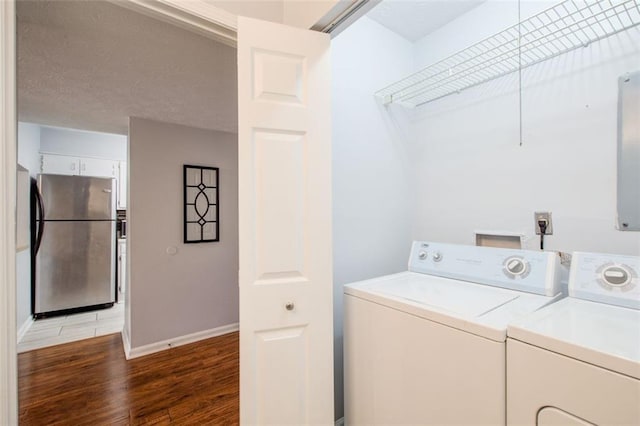 washroom featuring dark hardwood / wood-style flooring and washing machine and dryer