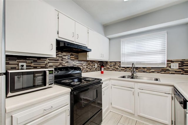 kitchen featuring stainless steel appliances, white cabinetry, sink, and backsplash