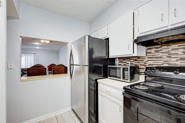 kitchen featuring appliances with stainless steel finishes, white cabinets, and backsplash