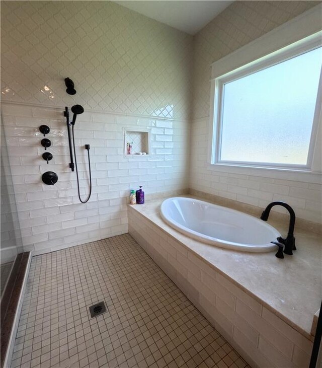 bathroom featuring tile patterned floors and independent shower and bath