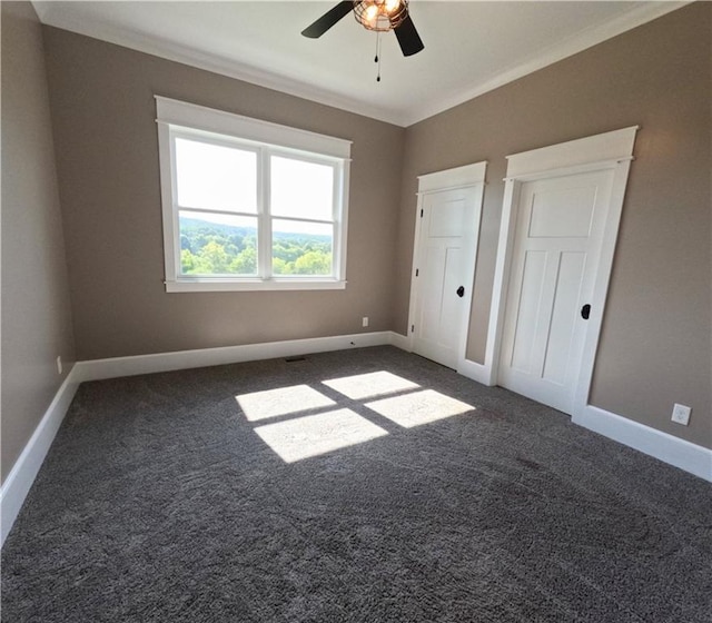 unfurnished bedroom with ceiling fan, ornamental molding, and carpet