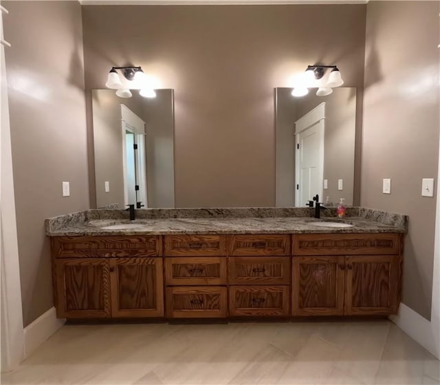 bathroom with dual vanity and tile patterned flooring