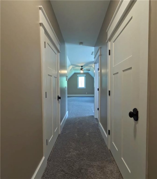 hall with vaulted ceiling and carpet floors