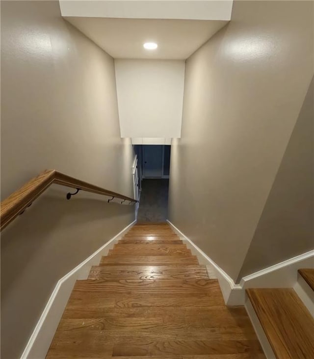 stairs featuring hardwood / wood-style flooring