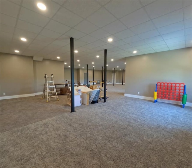 playroom with a paneled ceiling and light carpet